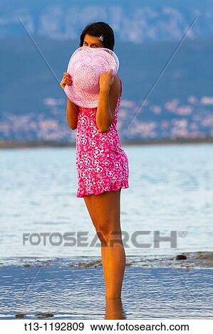Shy young woman behind a hat View Large Photo Image Stock Photo - Shy young woman behind a hat. Fotosearch