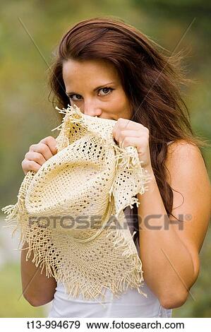 Shy young woman behind fluffy hat View Large Photo Image Stock Photo - Shy young woman behind fluffy hat. Fotosearch