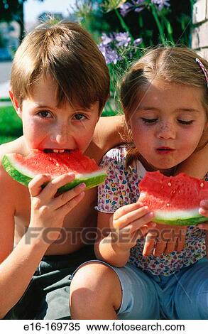 Siblings sharing watermelon View Large Photo Image Stock Photography - Siblings sharing watermelon. Fotosearch