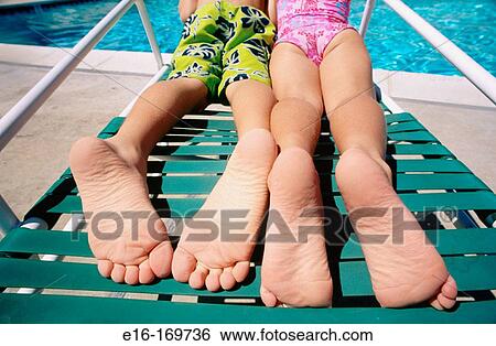 Siblings together on pool lounge chair View Large Photo Image Stock Photograph - Siblings together on pool lounge chair. Fotosearch