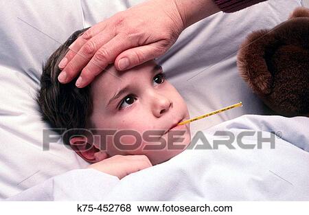 sick boy in bed with temperature View Large Photo Image Stock Photo - sick boy in bed with temperature. Fotosearch