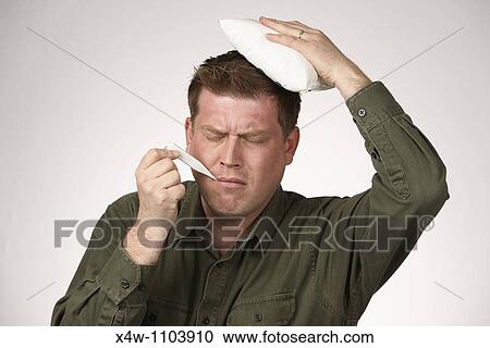 Sick man with digital thermometer in his mouth and ice pack on his head View Large Photo Image Stock Image - Sick man with digital thermometer in his mouth and ice pack on his head. Fotosearch