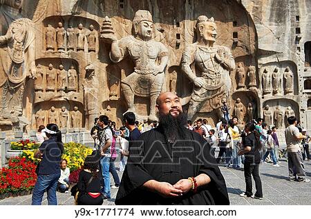 Sifu in front The Longmen Dragon's Gate Grottoes in Luoyang, China View Large Photo Image Picture - Sifu in front The Longmen Dragon's Gate Grottoes in Luoyang, China. Fotosearch