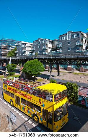 Sightseeing tour bus going through HafenCity warehouse district Hamburg Germany Europe View Large Photo Image Stock Photo - Sightseeing tour bus going through HafenCity warehouse district Hamburg Germany Europe. Fotosearch
