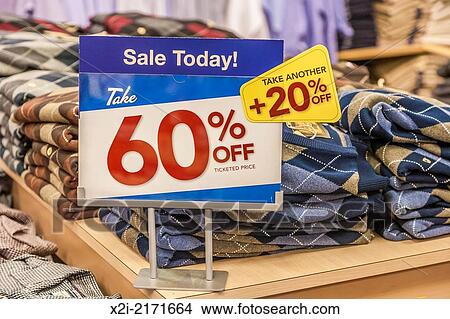 Sign indicates discounts on clothing in retail clothing bargain store. View Large Photo Image Picture - Sign indicates discounts on clothing in retail clothing bargain store.. Fotosearch