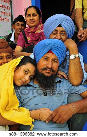 Stock Image - Sikh pilgrimage family in Gurudwara Temple in Manikaran. Fotosearch