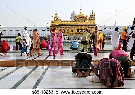 Stock Photography - Sikh pilgrims praying for the God in Golden Temple, Punjab Amritsar India. Fotosearch