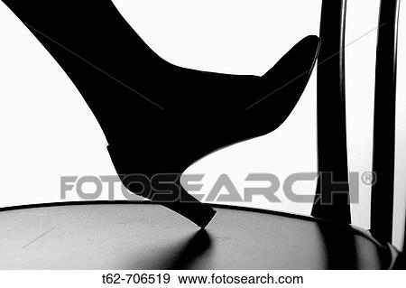 Silhouette against the foot of a woman's shoe in high-heeled shoe View Large Photo Image Stock Photo - Silhouette against the foot of a woman's shoe in high-heeled shoe. Fotosearch
