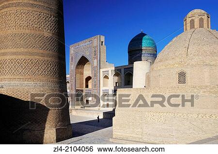 Stock Photograph - Silhouette in front of Mir-i-Arab Madrasa with Kalon minaret in the foreground. Uzbekistan, Bukhara.. Fotosearch