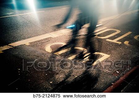 silhouette of a bike in movement at night running through London Bridge and text on the asphalt. London, England, UK View Large Photo Image Stock Photography - silhouette of a bike in movement at night running through London Bridge and text on the asphalt. London, England, UK. Fotosearch