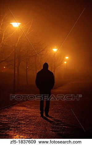 Silhouette of a man on a foggy evening View Large Photo Image Stock Photo - Silhouette of a man on a foggy evening. Fotosearch