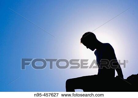 Silhouette of a man on a rock. Nerja, Spain View Large Photo Image Stock Photo - Silhouette of a man on a rock. Nerja, Spain. Fotosearch