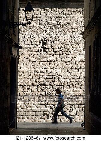 Silhouette of a man passing by the Church of Santa Maria del Mar, Ciutat Vella district, Barcelona, Catalonia, Spain View Large Photo Image Stock Photo - Silhouette of a man passing by the Church of Santa Maria del Mar, Ciutat Vella district, Barcelona, Catalonia, Spain. Fotosearch