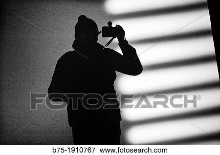silhouette of a man taking a photo View Large Photo Image Stock Photo - silhouette of a man taking a photo. Fotosearch