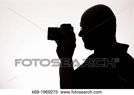 silhouette of a man with a camera View Large Photo Image Stock Photography - silhouette of a man with a camera. Fotosearch