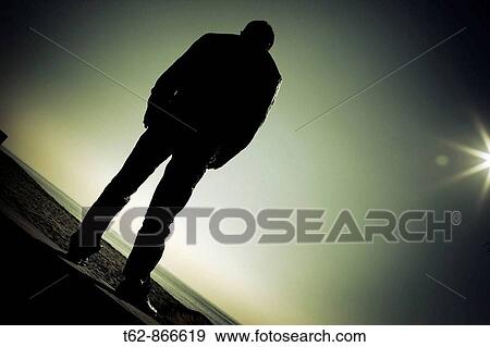 Silhouette of a man with backlight, resting View Large Photo Image Stock Photo - Silhouette of a man with backlight, resting. Fotosearch