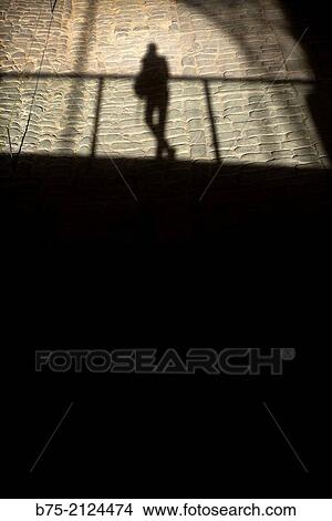 silhouette of a unrecognizable man, in relaxed position leaning on a railing at the Mercat del Born Barcelona, Spain, Europe View Large Photo Image Picture - silhouette of a unrecognizable man, in relaxed position leaning on a railing at the Mercat del Born Barcelona, Spain, Europe. Fotosearch