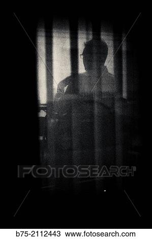 Silhouette of a unrecognizable man with glasses sitting, seen through a window in London, England, UK, Europe. View Large Photo Image Stock Image - Silhouette of a unrecognizable man with glasses sitting, seen through a window in London, England, UK, Europe.. Fotosearch