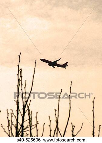 Stock Photograph - Silhouette of an airplane in the sky. Fotosearch
