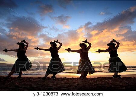 Stock Image - Silhouette of hula dancers at sunset at Palauea Beach, Maui, Hawaii. Fotosearch