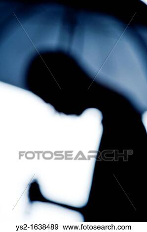 Silhouette of man holding an umbrella View Large Photo Image Stock Photo - Silhouette of man holding an umbrella. Fotosearch