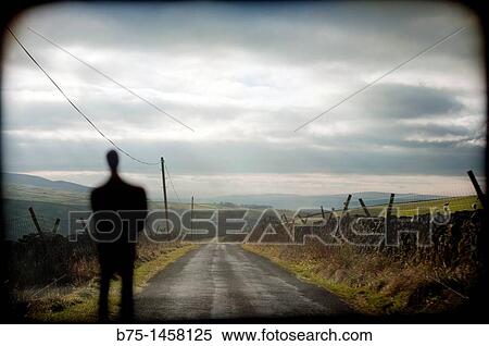 Silhouette of man in front of a country road View Large Photo Image Stock Photography - Silhouette of man in front of a country road. Fotosearch