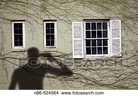 Picture - Silhouette of man with gun to his head. Fotosearch