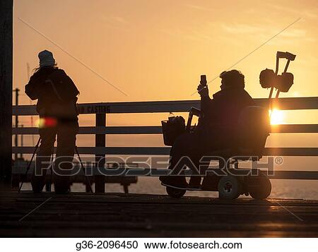 Silhouette of people looking at sea from pier, Pismo Beach, California. View Large Photo Image Stock Image - Silhouette of people looking at sea from pier, Pismo Beach, California.. Fotosearch