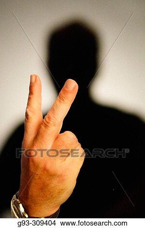 Picture - Silhouette of person holding up two fingers. Fotosearch