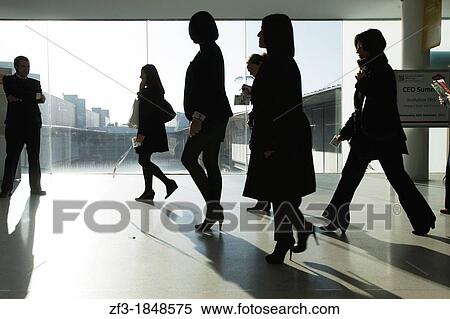Silhouette of some people in the hall of a congress center in Fira Barcelona, Barcelona View Large Photo Image Stock Photography - Silhouette of some people in the hall of a congress center in Fira Barcelona, Barcelona. Fotosearch