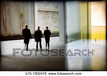 Stock Photograph - silhouette of three business men walking. Fotosearch