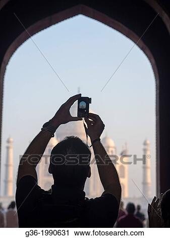 Stock Image - Silhouette of tourists at Taj Mahal in Agra, Uttar Pradesh, India.. Fotosearch