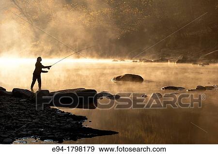 Silhouette profile of a young woman casting with a fly fishing rod by a stream early in the morning, north central, Alabama, USA. View Large Photo Image Stock Photo - Silhouette profile of a young woman casting with a fly fishing rod by a stream early in the morning, north central, Alabama, USA.. Fotosearch