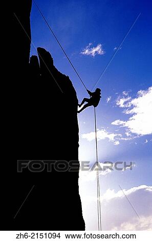Silhouetted climber rappelling from the summit of Eichorn Pinnacle, Yosemite National Park, California USA. View Large Photo Image Picture - Silhouetted climber rappelling from the summit of Eichorn Pinnacle, Yosemite National Park, California USA.. Fotosearch