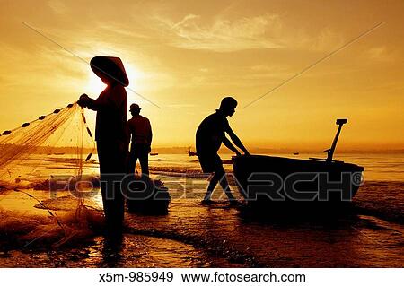 Silhouetted fishermen on Mui Ne Beach in Vietnam View Large Photo Image Stock Photo - Silhouetted fishermen on Mui Ne Beach in Vietnam. Fotosearch