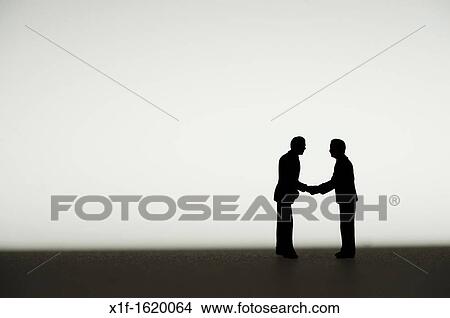silhouetted small figures conceptual image for business men meeting View Large Photo Image Picture - silhouetted small figures conceptual image for business men meeting. Fotosearch