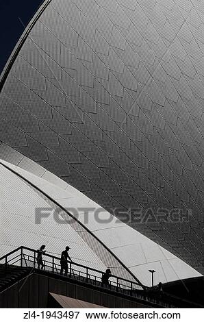Stock Photo - Silhouettes in front of Sydney Opera House and its wonderful curves. Australia, New South Wales, Sydney.. Fotosearch