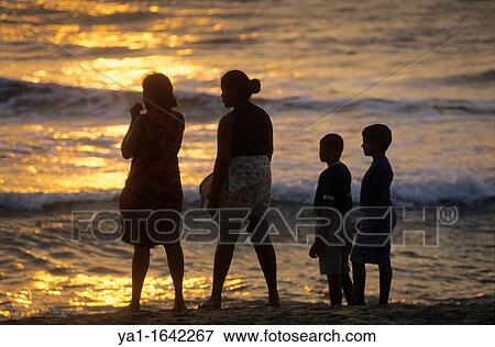 Silhouettes of family watching sunset on beach, Kalutara, Sri Lanka View Large Photo Image Stock Photo - Silhouettes of family watching sunset on beach, Kalutara, Sri Lanka. Fotosearch
