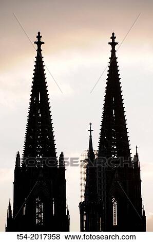 Stock Photo - Silhouettes of the towers of Cologne Cathedral at dusk. Fotosearch