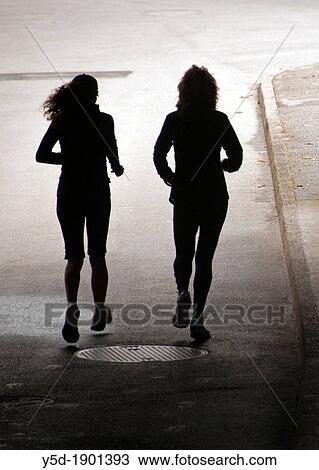 silhouettes of two women running together, backlit, pedestrian passage under railroad tracks, any place is good for runners in Geneva, healthcare and fitness has primary meaning for people in Geneva, Switzerland View Large Photo Image Stock Image - silhouettes of two women running together, backlit, pedestrian passage under railroad tracks, any place is good for runners in Geneva, healthcare and fitness has primary meaning for people in Geneva, Switzerland. Fotosearch