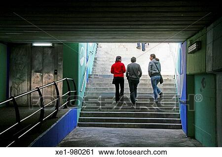 Stock Image - Silhouettes, tunnel access to beach, Arenys de Mar, Catalonia, Spain.. Fotosearch