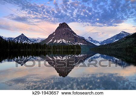 Sinapah Mountain reflected in Two Medicine Lake at dawn, Glacier National Park (Two Medicine sector), Montana, USA. View Large Photo Image Stock Photo - Sinapah Mountain reflected in Two Medicine Lake at dawn, Glacier National Park (Two Medicine sector), Montana, USA.. Fotosearch