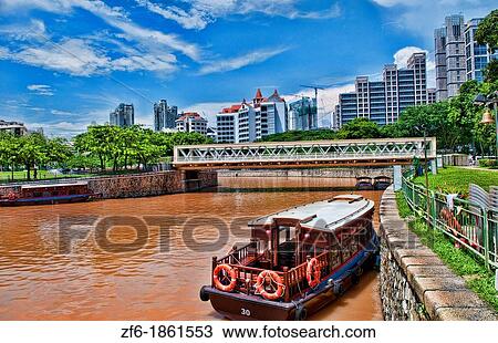 Singapore downtown river in Fullerton Area of Clarke Quay with tourist couple tug boats on water View Large Photo Image Stock Image - Singapore downtown river in Fullerton Area of Clarke Quay with tourist couple tug boats on water. Fotosearch