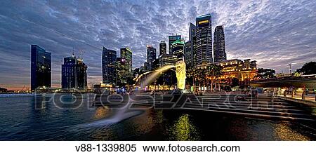 Stock Photography - Singapore skyline and Merlion statue in evening twilight, viewed from Merlion Park, Singapore. Fotosearch