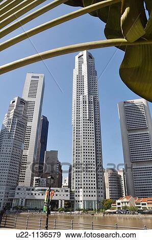 Stock Photo - Singapore: skyscrapers and old houses along the Singapore River's bank. Fotosearch