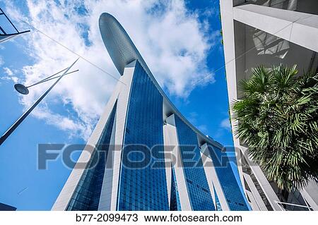 Singapore, worm's eye view of the bold architecture of the Marina Bay Sands Hotel and skypark complex, the three 200 metre hotel towers are conected at the top by 9941 square metres skypark bridge. View Large Photo Image Stock Image - Singapore, worm's eye view of the bold architecture of the Marina Bay Sands Hotel and skypark complex, the three 200 metre hotel towers are conected at the top by 9941 square metres skypark bridge.. Fotosearch