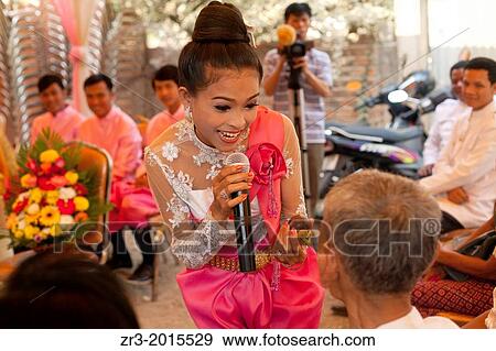 Singer at a buddhist wedding in a small village outside of Phnom Penh, Cambodia. View Large Photo Image Stock Photo - Singer at a buddhist wedding in a small village outside of Phnom Penh, Cambodia.. Fotosearch