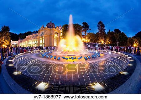 ? Singing Fountain? at dusk, surrounded by the public that congregate to see the show of water, lights and music Marianske Lazne, Bohemia, Czech Republic, Europe View Large Photo Image Stock Photo - ? Singing Fountain? at dusk, surrounded by the public that congregate to see the show of water, lights and music Marianske Lazne, Bohemia, Czech Republic, Europe. Fotosearch