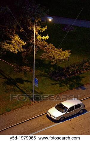 single car parked on the street illuminated by a street lamp, nightscape View Large Photo Image Stock Photograph - single car parked on the street illuminated by a street lamp, nightscape. Fotosearch