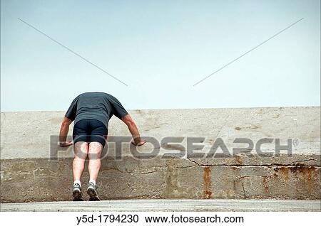 Stock Image - single man doing push-ups outdoor, Marseille, France. Fotosearch